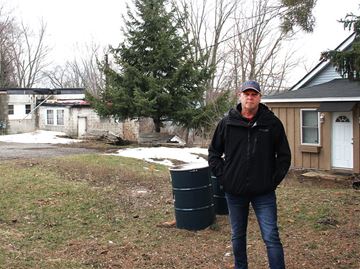 Dave Goad stands near the testing barrels on the property at 1390 Pineview Ave., where a proposed six-home development may be built.